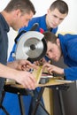 Apprentices learning to use circular saw Royalty Free Stock Photo