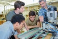 Apprentices learning to use machine Royalty Free Stock Photo