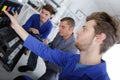 Apprentices technicians repairing office printer with teacher