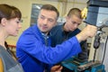 Apprentices working on machine - metal processing