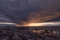 Approach of thunderstorm cloud at sunset. Royalty Free Stock Photo