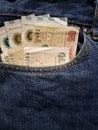 approach to front pocket of jeans in blue with argentinean banknotes