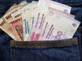 approach to front pocket of jeans in blue with argentinean banknotes