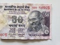 approach to Indian banknote of fifty rupees