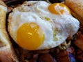 approach to a plate with fried eggs for breakfast, background and texture