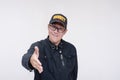 A approachable asian male security guard offers a handshake. Isolated on a white background