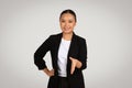 Approachable and friendly Asian businesswoman in a black blazer offering a handshake
