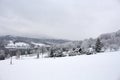 Approaching blizzard in mountain landscape. spruce trees on snow covered meadow. bad weather condition in winter. fog and clouds