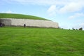 Approaching a grass covered passage tomb