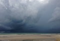 Approaching storm cloud with rain over the sea Royalty Free Stock Photo