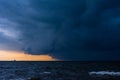 Approaching storm cloud with rain over the sea Royalty Free Stock Photo