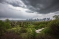 approaching storm clouds, with view of city skyline visible in the distance Royalty Free Stock Photo