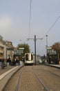 People getting on the tram in Nantes, Pays de la Loire, France on a cold misty day