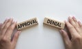 Approval or Denial symbol. Concept word Approval or Denial on wooden blocks. Businessman hand. Beautiful white background. Royalty Free Stock Photo