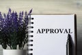 APPROVAL - word in a notepad with a marker and a bouquet of lavender on a light background