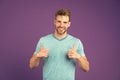 Approve or recommend concept. Man with brilliant smile unshaven face shows thumbs up gesture violet background. Man Royalty Free Stock Photo