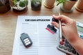 Approved car loan application with car key, rubber stamp and cal Royalty Free Stock Photo
