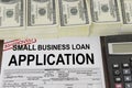 Approved small business loan application form and money