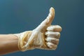 Approving sign Hand in rubber glove offers thumbs up gesture