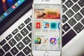 Apps List on Apple iPhone 6S display over Macbook keyboard Royalty Free Stock Photo