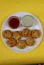 Appum or Appe, Appam or Mixed dal or Rava Appe served with green and red chutney. A Ball shape popular south Indian breakfast dish