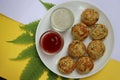 Appum or Appe, Appam or Mixed dal or Rava Appe served with green and red chutney. A Ball shape popular south Indian breakfast dish