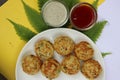 Appum or Appe, Appam or Mixed dal or Rava Appe served with green and red chutney. A Ball shape popular south Indian breakfast dish