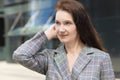 Appy adult woman. mature middle age businesswoman smiling near business centre. lady with long brunette ginger hair Royalty Free Stock Photo