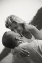 ÃÂappy couple a girl and a man in beach clothes hug against background of sea