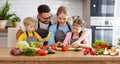 Appy family with child preparing vegetable salad