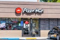 Apr 8, 2020 Redwood City / CA / USA - Pizza Hut restaurant open for take-out during the Shelter in Place order, letting only 2 Royalty Free Stock Photo