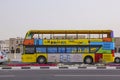 The tourist bus moves through the streets in Doha