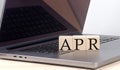 APR word on wooden block on laptop, business concept