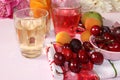 Apricot and cherry juice, apricots, cherries and grapes on a sunny table Royalty Free Stock Photo