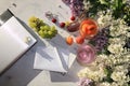 Apricot and cherry juice, apricots, cherries and grapes on a sunny table next to a notebook and laptop, copy space, top view. Royalty Free Stock Photo