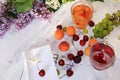 Apricot and cherry juice, apricots, cherries and grapes on a sunny table, top view. Royalty Free Stock Photo