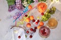 Apricot and cherry juice, apricots, cherries and grapes on a sunny table, top view Royalty Free Stock Photo