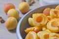 Apricot halves in a bowl, preparation for making preserves or jam Royalty Free Stock Photo