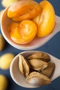 Apricot halves and kernels in wooden spoons. Top view Royalty Free Stock Photo