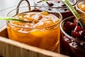 Apricot Jam in glass bowl with spoon and various fruit marmalade Royalty Free Stock Photo