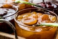 Apricot Jam in glass bowl with spoon and various fruit marmalade Royalty Free Stock Photo