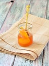 Apricot jam in a jar on napkin isolated light table