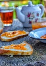 Apricot jam, sliced bread with jam and butter.