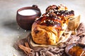 Apricot jam twisted loaf bread or babka with nuts and spices on concrete background with a cup of milk. Homemade yeast bun babka Royalty Free Stock Photo