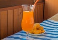 Apricot juice in a glass with straw and fresh fruit on napkin Royalty Free Stock Photo