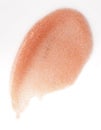 Apricot lipgloss smudge over white