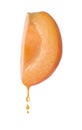 Apricot oil dripping from fresh cut fruit half on background Royalty Free Stock Photo