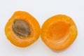 Apricot open up in two half with seed on the white background Royalty Free Stock Photo