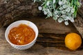 Apricot and peach jam in a small deep dish, sweet orange jam for dessert. Next to a whole fruit, apricots are marinated in syrup. Royalty Free Stock Photo