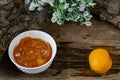 Apricot and peach jam in a small deep dish, sweet orange jam for dessert. Next to a whole fruit, apricots are marinated in syrup. Royalty Free Stock Photo